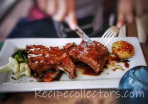 Memphis Style Barbecued Ribs with a smoky dry rub served on a rustic wooden platter after slow smoking.